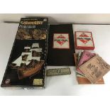 A boxed wooden modelling kit of the Grimsby English Frigate, Monopoly set, picture books,