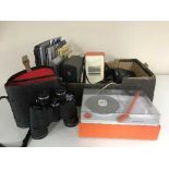 A box of cased Pathescope binoculars, Blaupunkt turn table and speakers, discman, books,