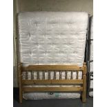 A 4'6 pine bed frame with silent night mirrorcoil mattress