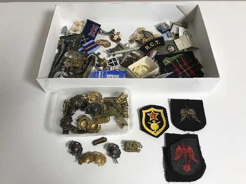 A box of military badges, cap badges, enamel examples,