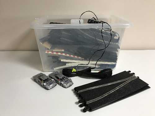 A box of Scalextric track and cars