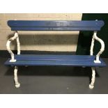An antique and later garden bench with cast iron ends