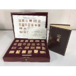 A cased silver proof stamp set: The Empire Collection, 25 gold-plated silver ingots,