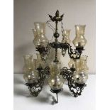 A brass and glass nine branch chandelier with glass drops