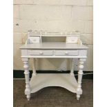 A contemporary white kneehole dressing table