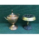 An antique copper and brass tea urn on brass trivet
