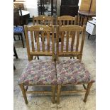 A set of four pine rail backed dining chairs
