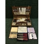 An oak canteen of cutlery together with a further eight boxes of cutlery