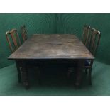A Victorian mahogany wind out dining table with three leaves together with a set of four Queen Ann