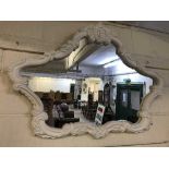 A contemporary white decorative overmantel mirror