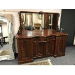 A Victorian inverted breakfront mahogany mirror back sideboard