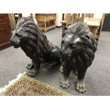 A pair of bronze seated lion figures