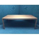 A large teak writing desk fitted with four drawers together with matching teak table