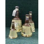 A set of four graduated bells whisky decanters (sealed)