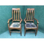 A pair of Edwardian oak high backed armchairs