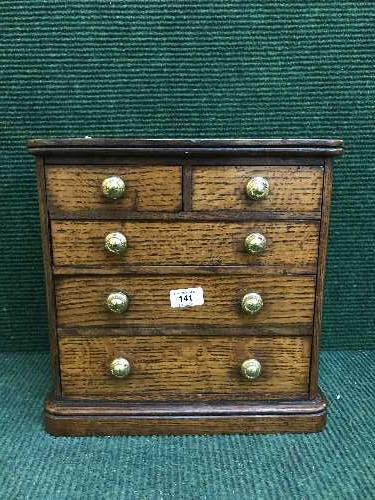 A miniature Victorian oak five drawer chest