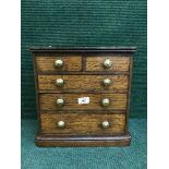 A miniature Victorian oak five drawer chest