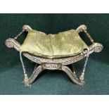 An antique gilt wood scroll end dressing table stool