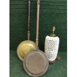 Two copper and brass bed warming pans together with a pottery table lamp on mahogany base