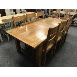 A solid oak extending dining table with two leaves and six chairs