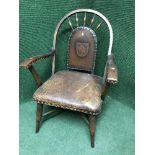 A Victorian oak armchair upholstered in buttoned leather