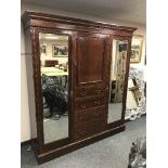 An Edwardian inlaid mahogany triple door wardrobe