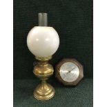 A brass Duplex oil lamp with glass shade and chimney together with an oak barometer