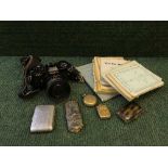 A basket containing Yashica FR1 camera, tortoiseshell cigarette case, vesta box,