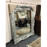 A bevelled silvered overmantel mirror