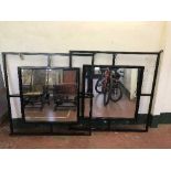 Two large metal framed shop wall mirrors