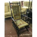 An American mahogany rocking chair upholstered in tapestry covering