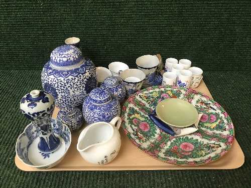 A tray of oriental china including wall plates, sake cups, lidded ginger jars,