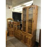 A pine glazed door display cabinet fitted with cupboards beneath together with accompanying chest