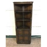 An Ercol corner cabinet