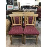 A set of four pine chairs upholstered in a burgandy fabric