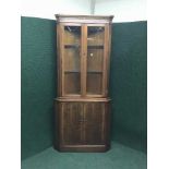 A Strongbow inlaid yewwod glazed door corner cabinet