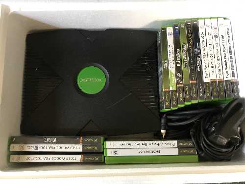 A box of Xbox with leads and controller,