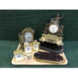 A tray of continental brass and marble mantle clock with key, four battery powered clocks,
