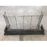 An antique brass framed fire guard together with a metal fire curb