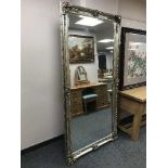 A large silvered bevelled overmantle mirror