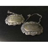 Two silver decanter labels,