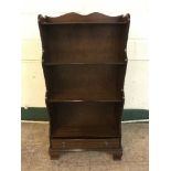 A set of mahogany open bookshelves fitted with a drawer