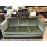 An early twentieth century three seater settee upholstered in green dralon fabric