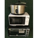 An Andrew James table oven together with a Brevelle slow cooker and a microwave