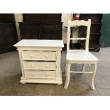 A contemporary white three drawer chest with chair