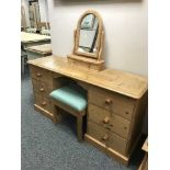 A pine kneehole dressing table with mirror and stool
