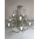 A decorative nine branch chandelier with glass drops