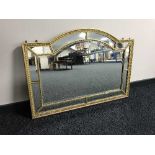 A shaped gilt framed over mantel mirror