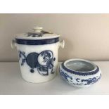 An oriental glazed pottery lidded jar and a shallow blue and white bowl depicting dragons