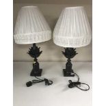 A pair of contemporary black table lamps with shades